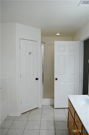 a view of kitchen with white cabinets