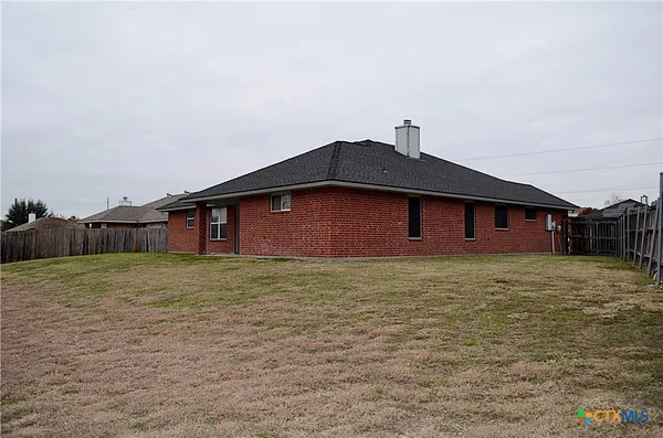 a backyard of a house with wooden fence