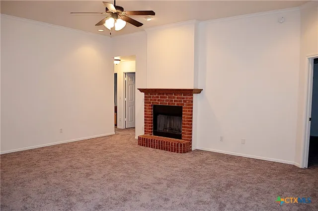 an empty room with a fireplace and fan
