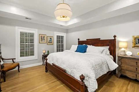 a bed sitting in a bedroom next to a window
