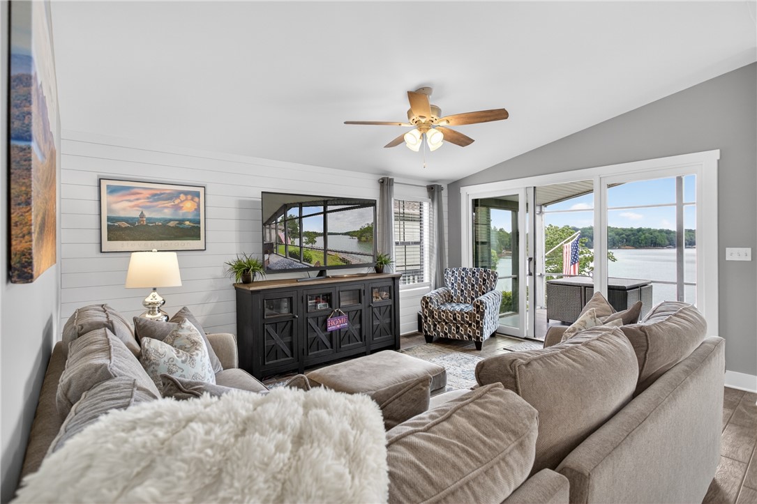 1230 Melton Road, Unit 4 West Union, SC 29696 - Photo 44 of 48 Unwind in this inviting living space, offering tranquil waterfront views through sliding glass doors.
