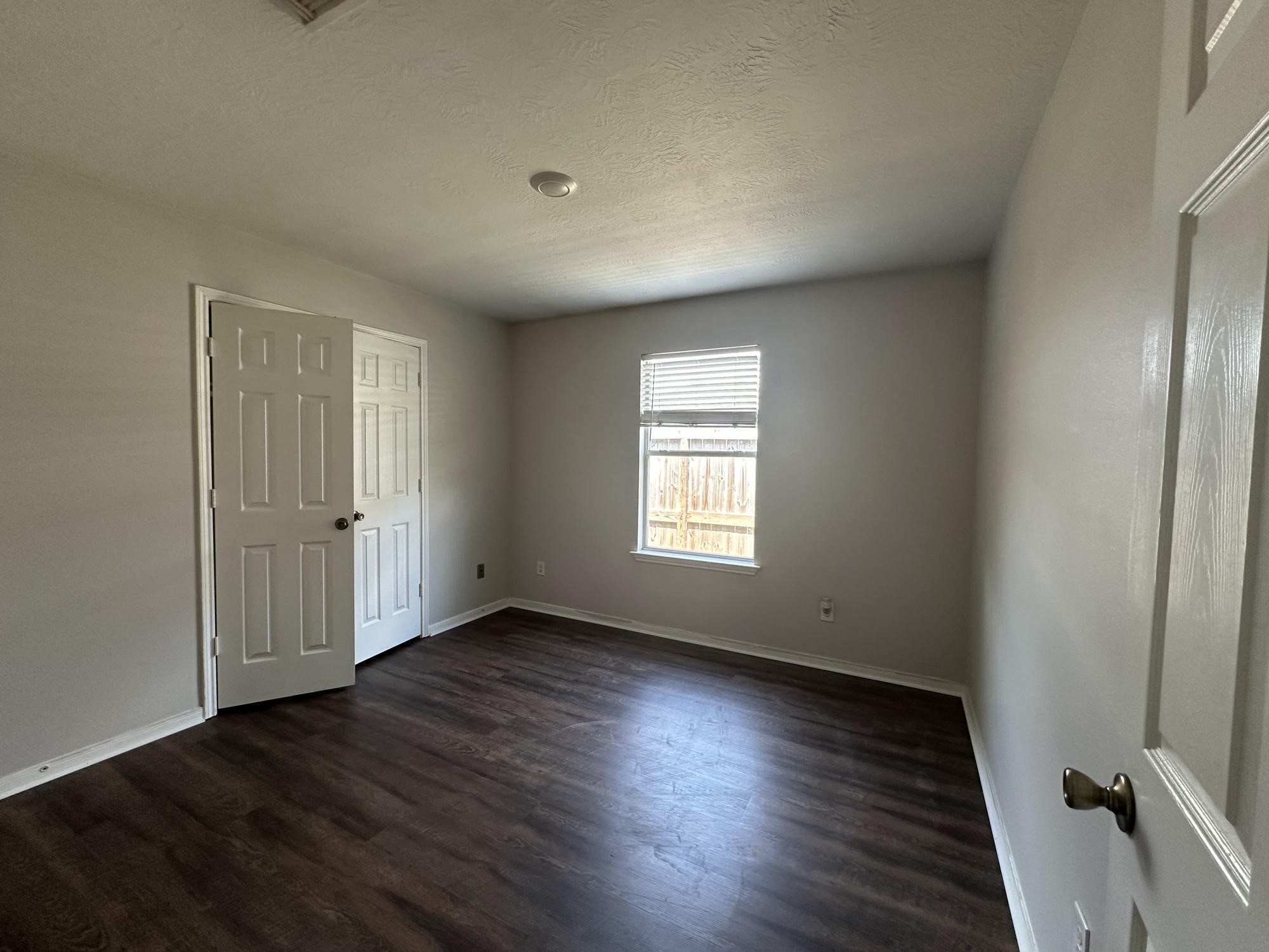 1034 Junction Court Rosenberg, TX 77471 - Photo 14 of 19 an empty room with wooden floor and windows