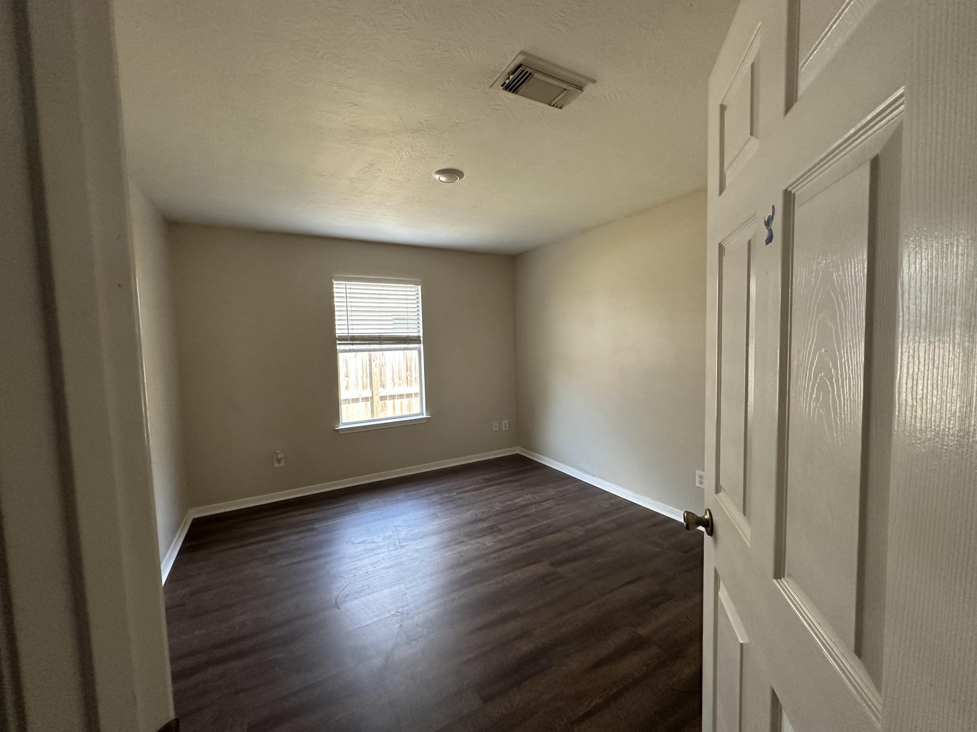 1034 Junction Court Rosenberg, TX 77471 - Photo 16 of 19 an empty room with wooden floor and windows