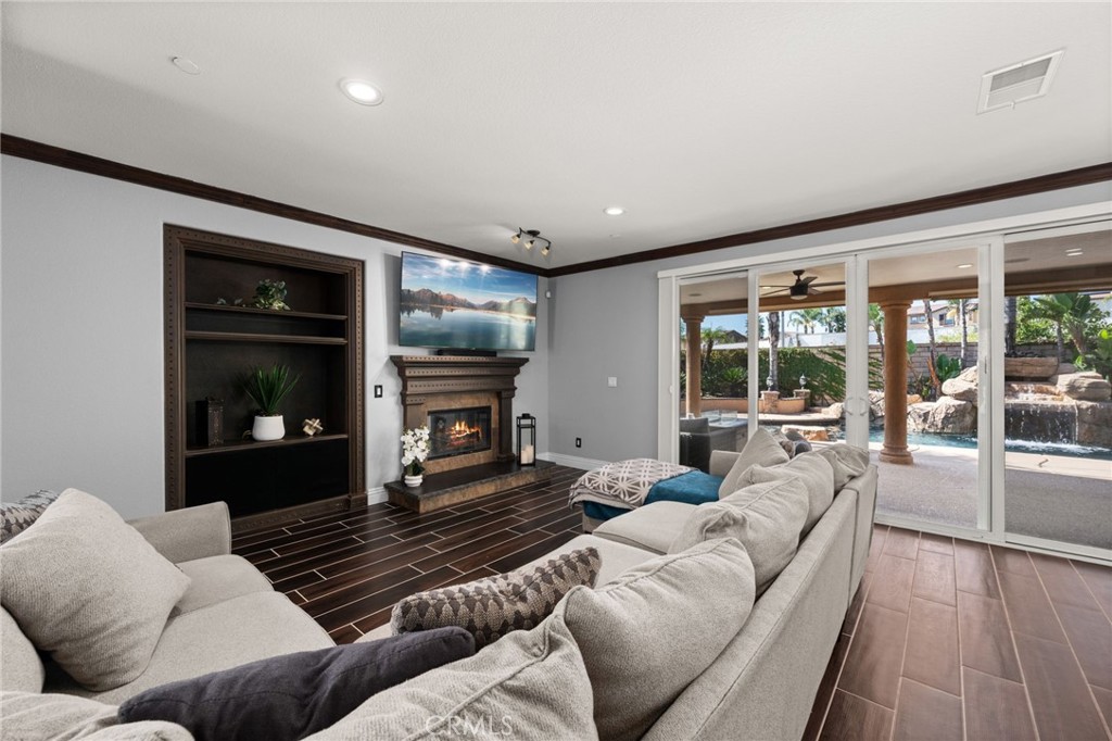 6336 Taylor Canyon Place Rancho Cucamonga, CA 91739 - Photo 13 of 60 a living room with furniture and a fireplace