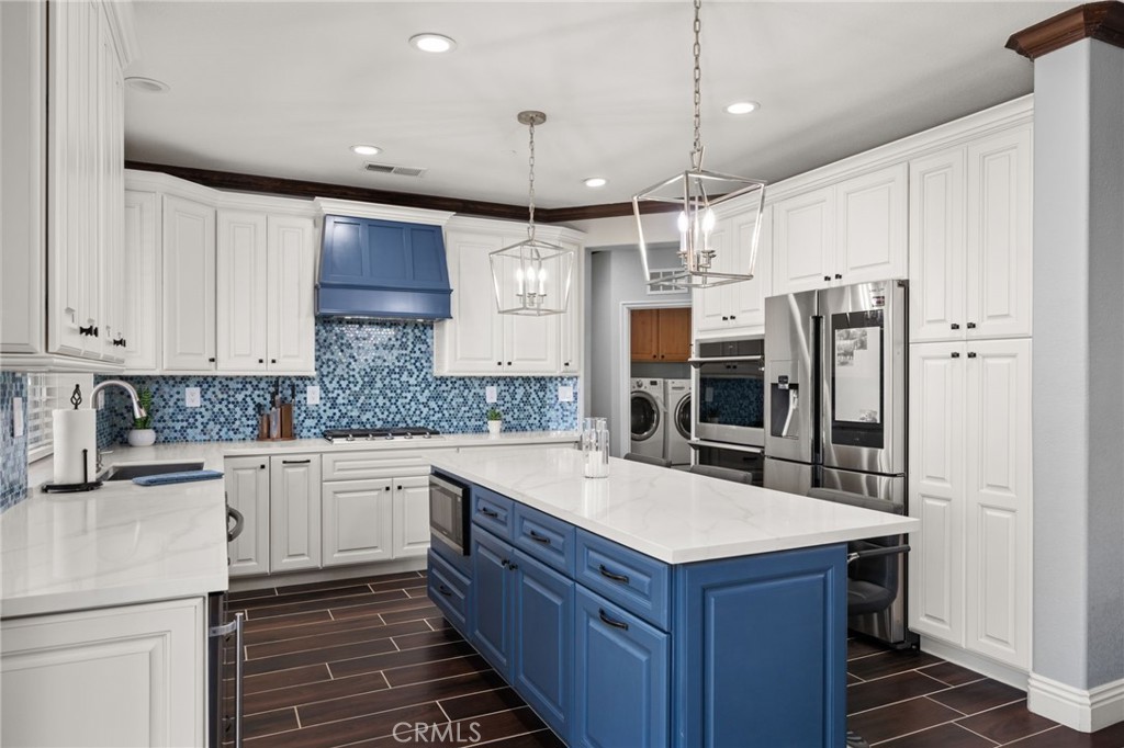 6336 Taylor Canyon Place Rancho Cucamonga, CA 91739 - Photo 15 of 60 a kitchen with granite countertop a sink and refrigerator