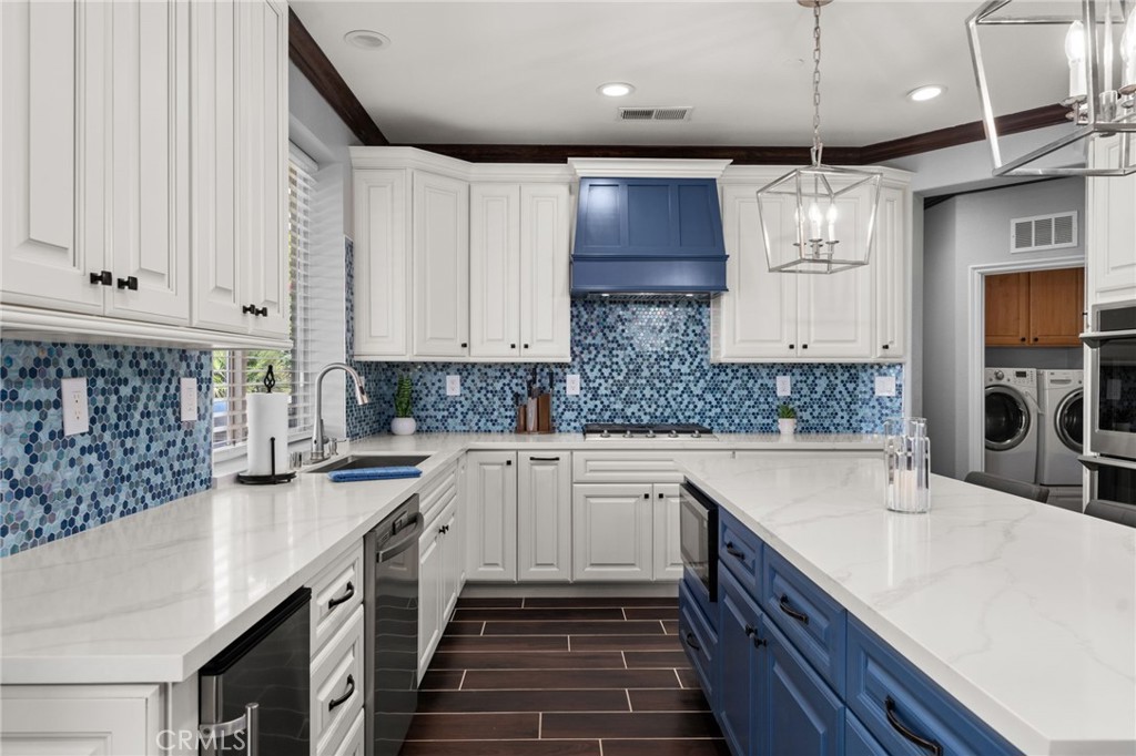 6336 Taylor Canyon Place Rancho Cucamonga, CA 91739 - Photo 16 of 60 a kitchen with stainless steel appliances a sink stove and cabinets