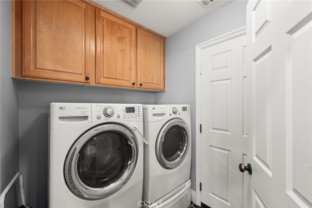 6336 Taylor Canyon Place Rancho Cucamonga, CA 91739 - Photo 22 of 60 a close view of a utility room with dryer and washer