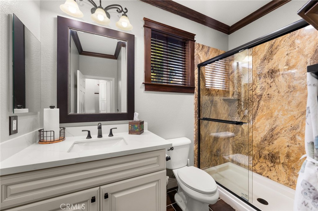 6336 Taylor Canyon Place Rancho Cucamonga, CA 91739 - Photo 25 of 60 a bathroom with a sink a toilet a mirror and shower
