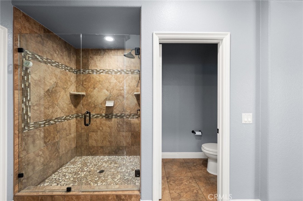 6336 Taylor Canyon Place Rancho Cucamonga, CA 91739 - Photo 33 of 60 a bathroom with a granite countertop shower