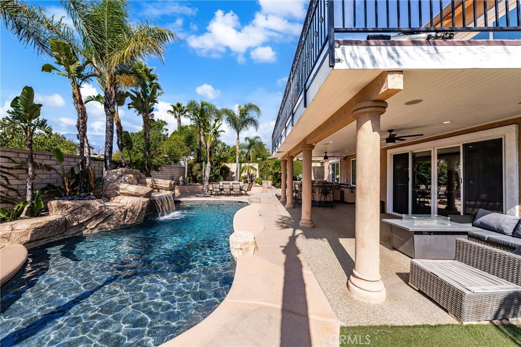 6336 Taylor Canyon Place Rancho Cucamonga, CA 91739 - Photo 46 of 60 a view of a patio with couches and table and chairs with wooden fence and plants