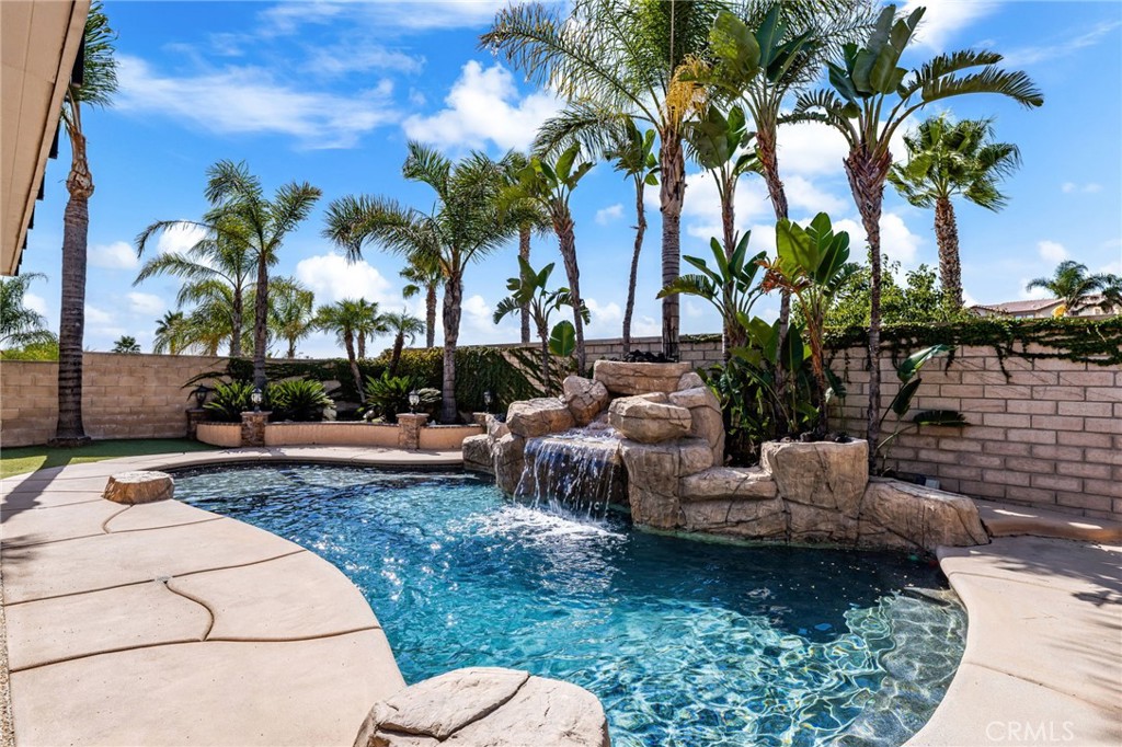 6336 Taylor Canyon Place Rancho Cucamonga, CA 91739 - Photo 50 of 60 a view of a backyard with couches plants and palm tree