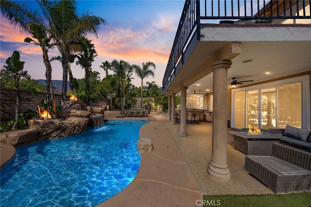 6336 Taylor Canyon Place Rancho Cucamonga, CA 91739 - Photo 53 of 60 a swimming pool with outdoor seating and a garden