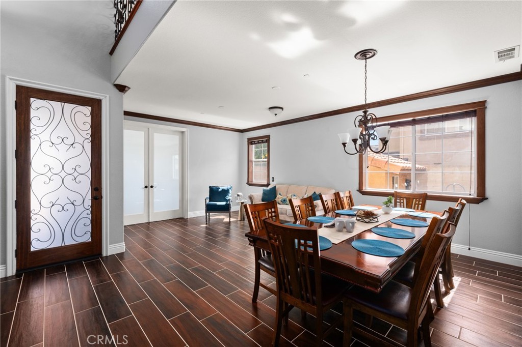 6336 Taylor Canyon Place Rancho Cucamonga, CA 91739 - Photo 9 of 60 a view of a dining room with furniture window and wooden floor