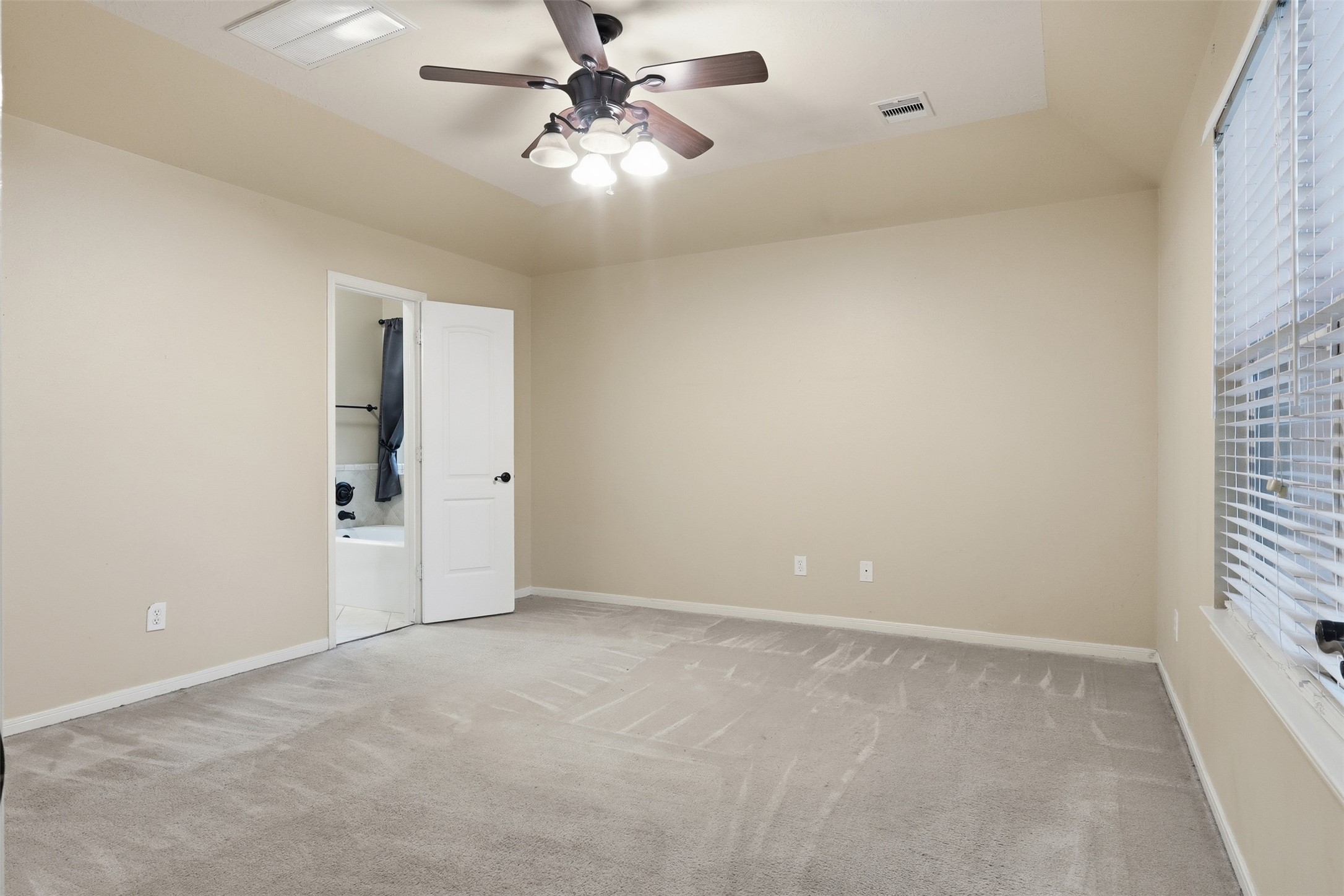 17423 Morning Star Avenue Crosby, TX 77532 - Photo 12 of 23 an empty room with chandelier fan and windows