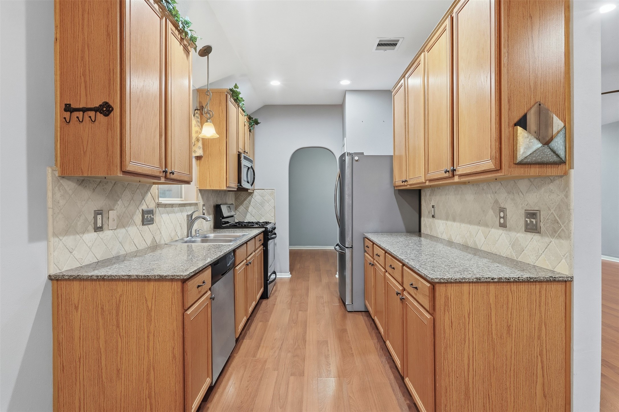 17423 Morning Star Avenue Crosby, TX 77532 - Photo 5 of 23 a kitchen with stainless steel appliances granite countertop a sink and a refrigerator