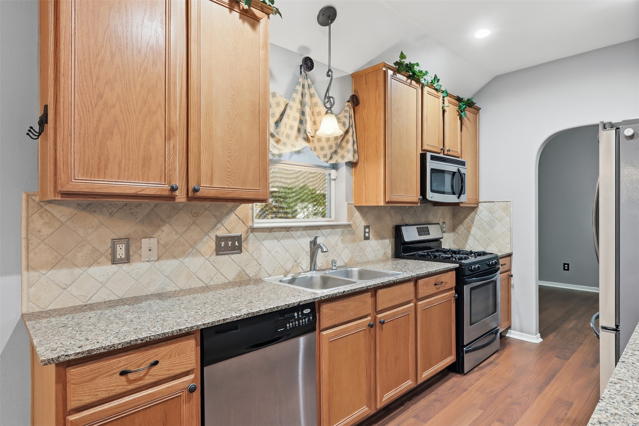 17423 Morning Star Avenue Crosby, TX 77532 - Photo 7 of 23 a kitchen with stainless steel appliances granite countertop a sink stove and refrigerator