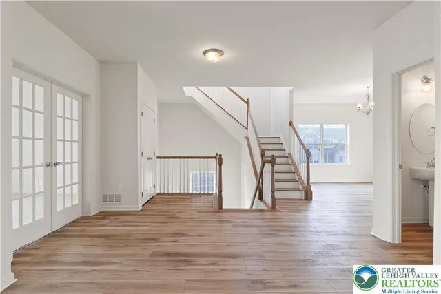 a view of entryway and hall with wooden floor