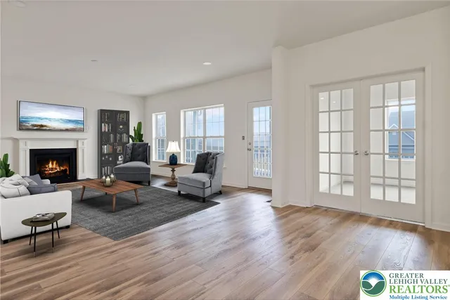 a living room with furniture wooden floor and a fireplace