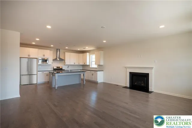 a kitchen with a refrigerator and a stove top oven