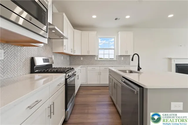 a kitchen with a sink stove and refrigerator