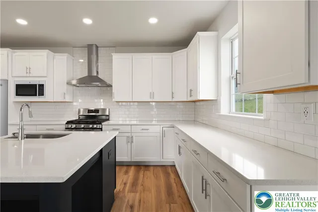 a kitchen with a sink a stove and cabinets