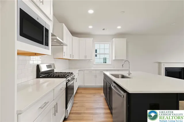 a kitchen with a sink stove and microwave