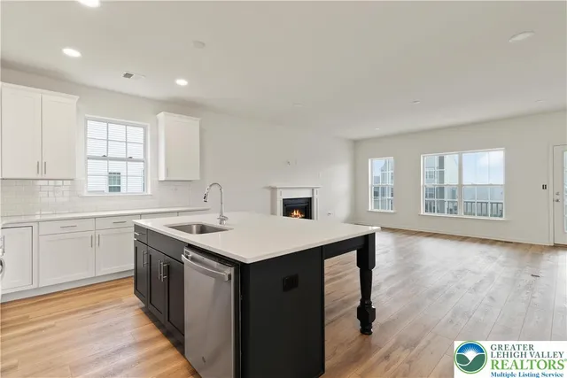 a kitchen with a sink stove and cabinets