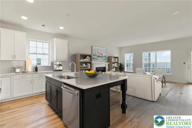 a kitchen with sink cabinets and wooden floor