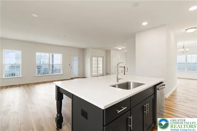 a kitchen with a sink cabinets and wooden floor