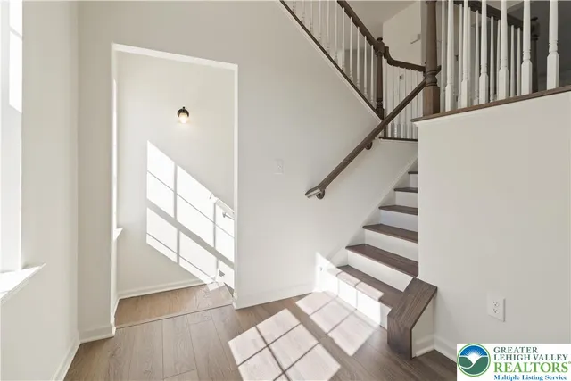 a view of entryway and hall with wooden floor