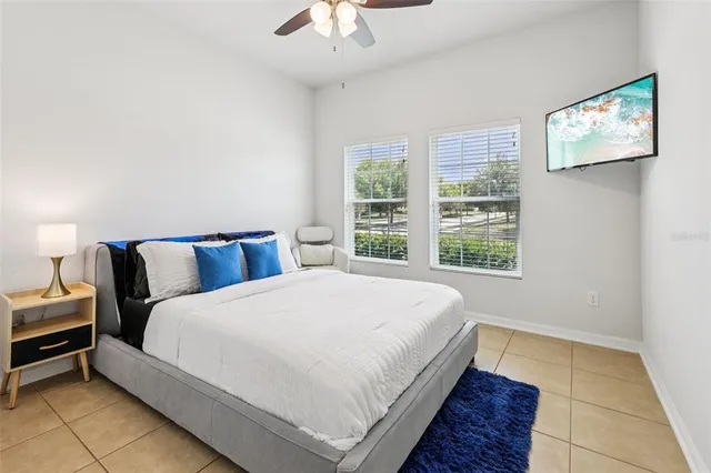a large bed sitting in a bedroom next to a window