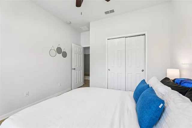 a bedroom with a bed and a lamp