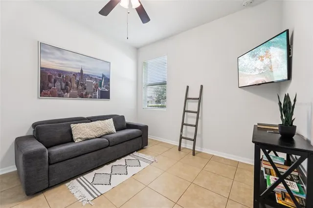 a living room with furniture a desk and chair