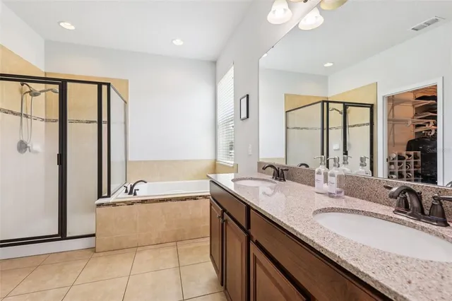 a bathroom with a granite countertop sink and a large mirror