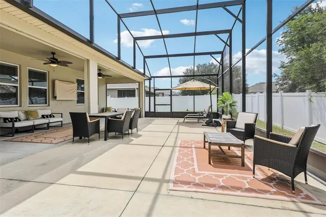 a view of a patio with table and chairs potted plants with wooden floor