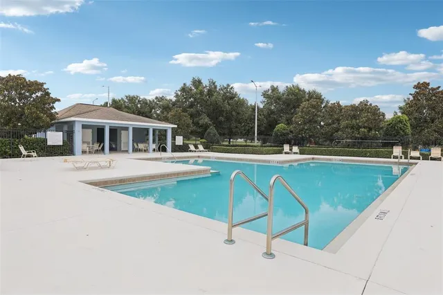 a view of a swimming pool and a yard