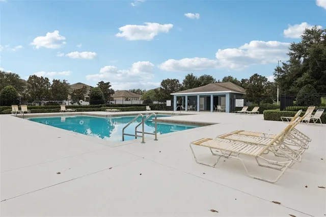 a view of a house with swimming pool and sitting area