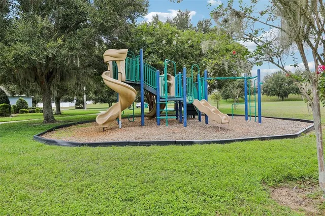 a view of outdoor space with playground and green space