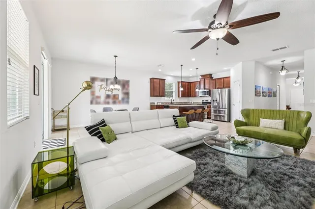 a living room with furniture and a chandelier