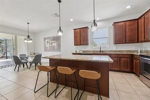 a kitchen with a dining table cabinets and appliances
