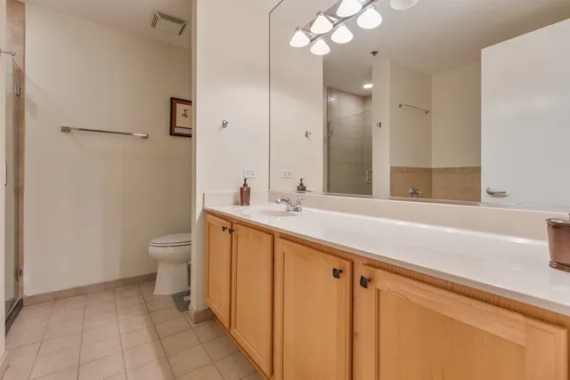 a spacious bathroom with a granite countertop sink mirror and toilet