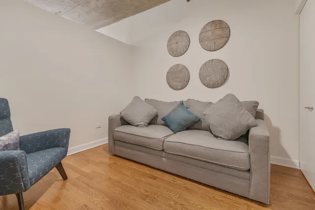 a large white couch sitting next to a white cabinet