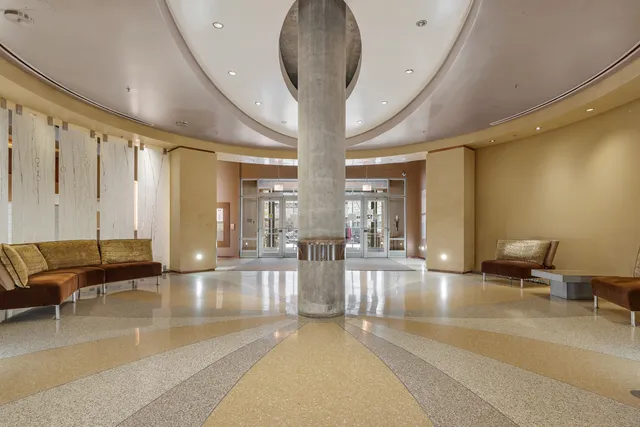 a view of a lobby with furniture and floor to ceiling window