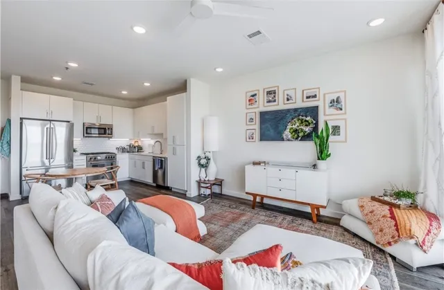 a living room with furniture and cabinets
