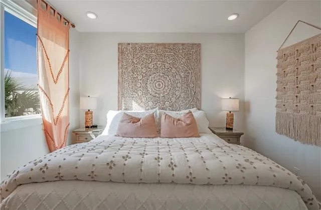 a bedroom with a large bed and a window