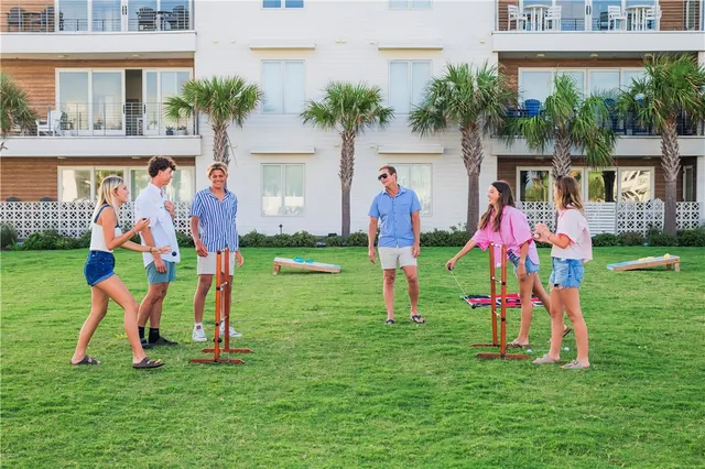 a front view of multi story residential apartment building with yard