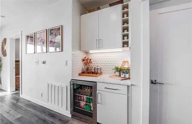 a kitchen with stainless steel appliances cabinets and a window