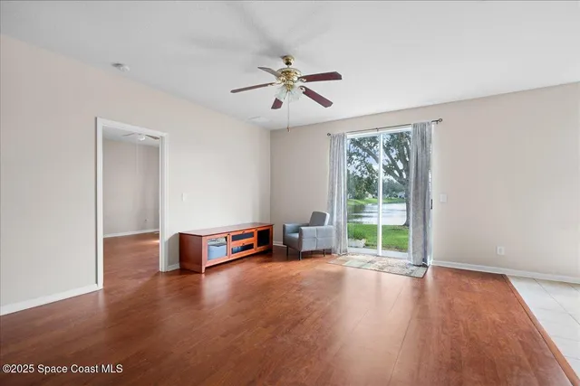 wooden floor in an empty room with a window