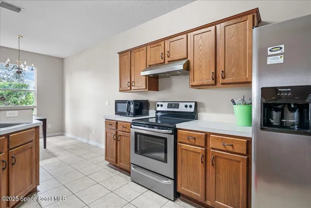a kitchen with stainless steel appliances granite countertop a stove and a sink
