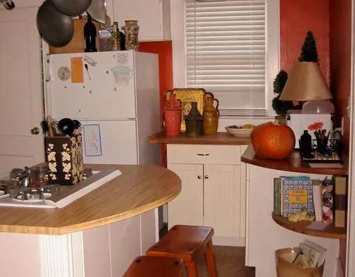 a kitchen with a refrigerator and a stove